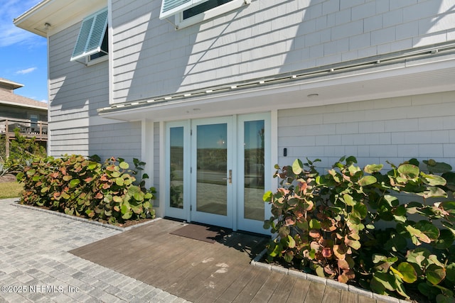 view of exterior entry featuring a patio and french doors