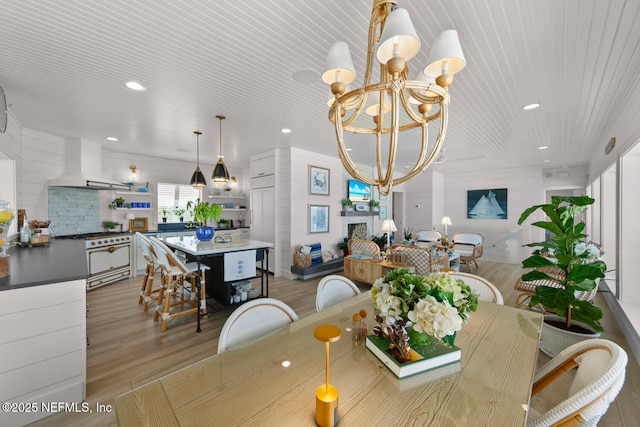 dining area with an inviting chandelier, wood ceiling, and light hardwood / wood-style flooring