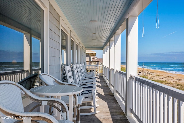 balcony with a beach view and a water view