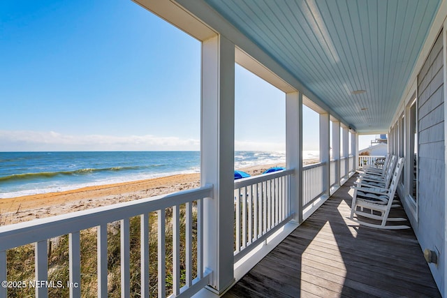 balcony with a beach view and a water view