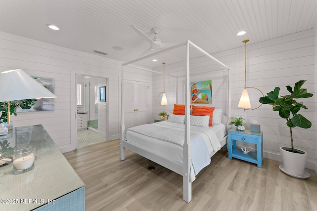 bedroom featuring ceiling fan, a closet, and hardwood / wood-style floors