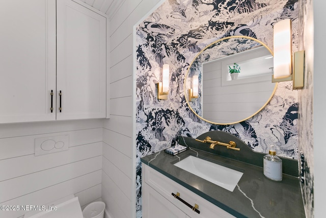 bathroom featuring wood walls and vanity