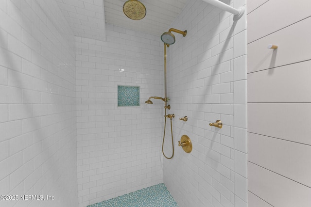 bathroom with a tile shower