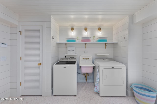 clothes washing area with sink and washer and clothes dryer