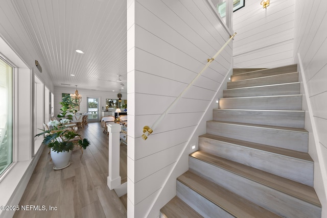 staircase with hardwood / wood-style floors