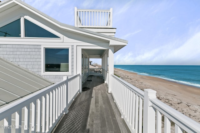 exterior space featuring a beach view and a water view