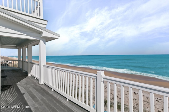 exterior space featuring a beach view and a water view