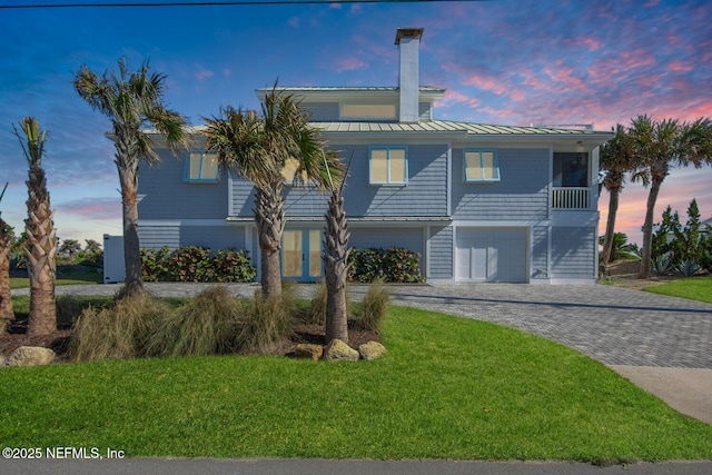 view of front of home with a yard and a garage