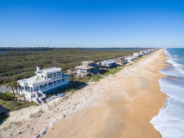 aerial view featuring a water view and a view of the beach