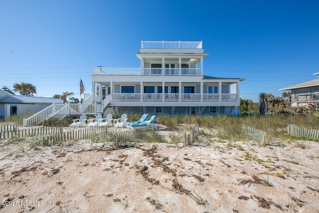 rear view of property featuring covered porch