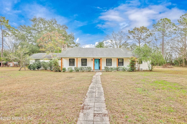 ranch-style home featuring covered porch and a front lawn