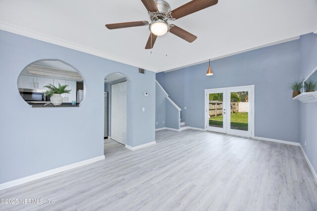 unfurnished living room with light hardwood / wood-style floors, french doors, crown molding, and ceiling fan