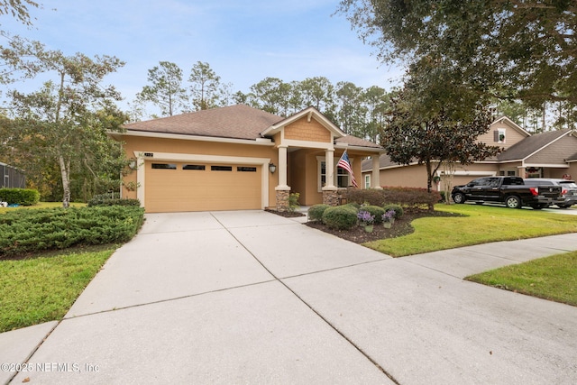 view of front of home with a front yard and a garage