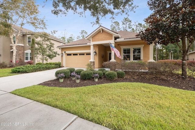 craftsman inspired home with a front yard and a garage