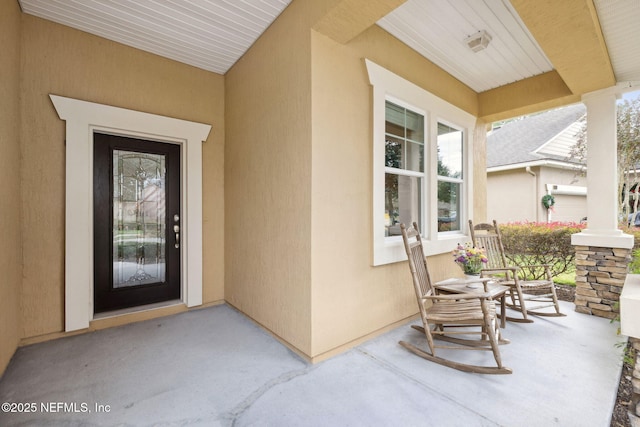 view of exterior entry with covered porch