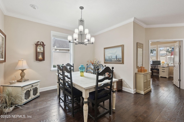 dining room featuring dark hardwood / wood-style floors, ornamental molding, and a notable chandelier