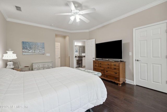 bedroom featuring dark hardwood / wood-style flooring, ensuite bath, ceiling fan, and ornamental molding