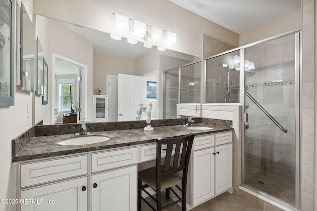 bathroom featuring vanity, tile patterned floors, and an enclosed shower