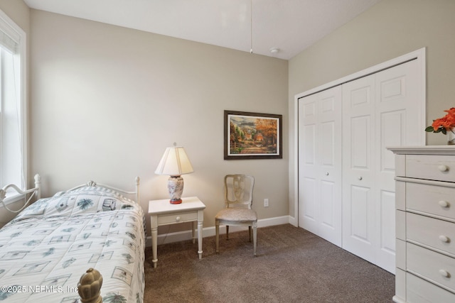 bedroom with dark carpet and a closet