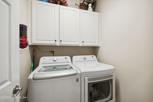 laundry area with cabinets and washing machine and dryer