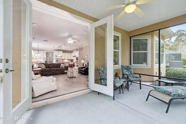 sunroom featuring plenty of natural light and ceiling fan