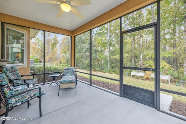 unfurnished sunroom with ceiling fan and a healthy amount of sunlight