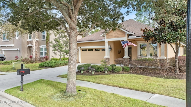 view of front of home with a front yard and a garage