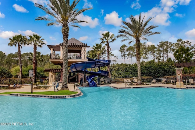 view of swimming pool with a pergola and a water slide