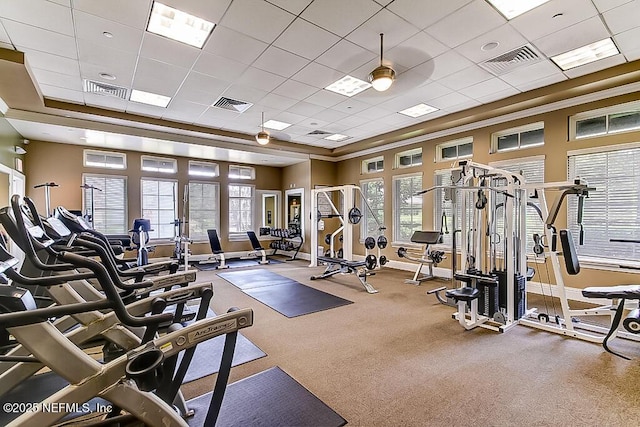 exercise room with a paneled ceiling and ceiling fan