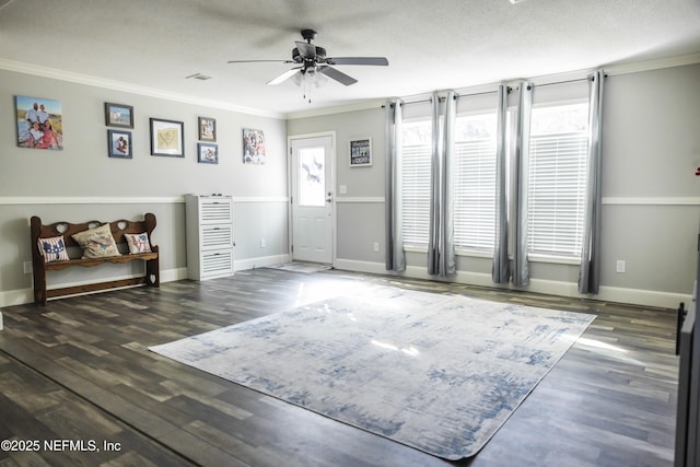 interior space featuring crown molding, ceiling fan, and a healthy amount of sunlight