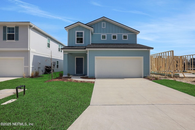 view of front of property featuring driveway, board and batten siding, an attached garage, and a front yard