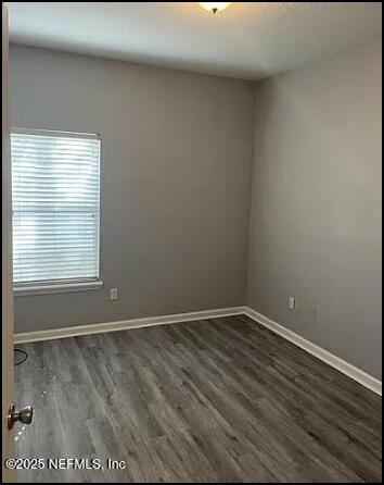 spare room featuring dark hardwood / wood-style floors