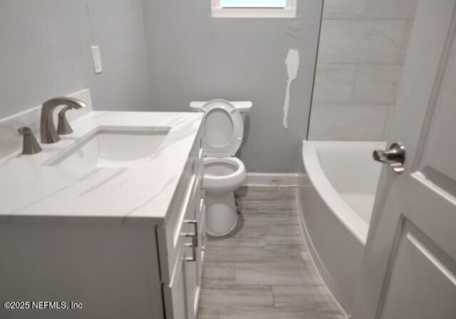 full bathroom with vanity, shower with separate bathtub, and toilet