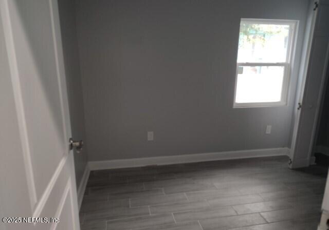 spare room featuring dark wood-type flooring