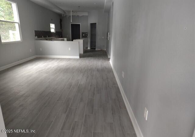 unfurnished living room with dark hardwood / wood-style floors