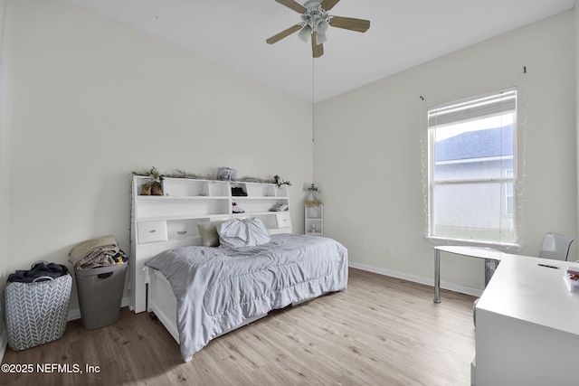 bedroom with multiple windows, ceiling fan, and light hardwood / wood-style flooring