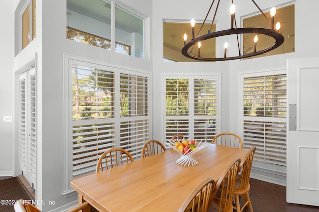 dining space featuring a notable chandelier and dark hardwood / wood-style flooring