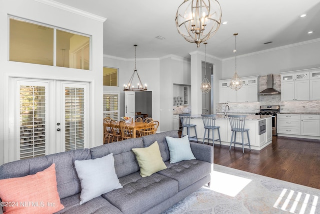 living room featuring ornamental molding, dark wood-type flooring, and french doors