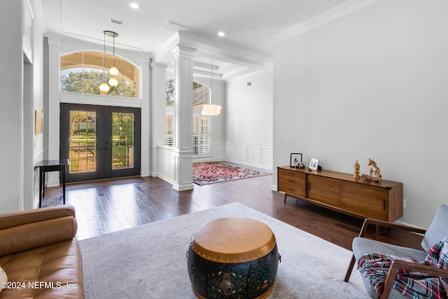 foyer featuring french doors, dark hardwood / wood-style flooring, decorative columns, and ornamental molding