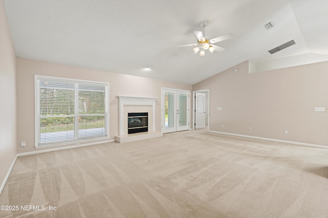 unfurnished living room featuring light carpet, vaulted ceiling, and ceiling fan