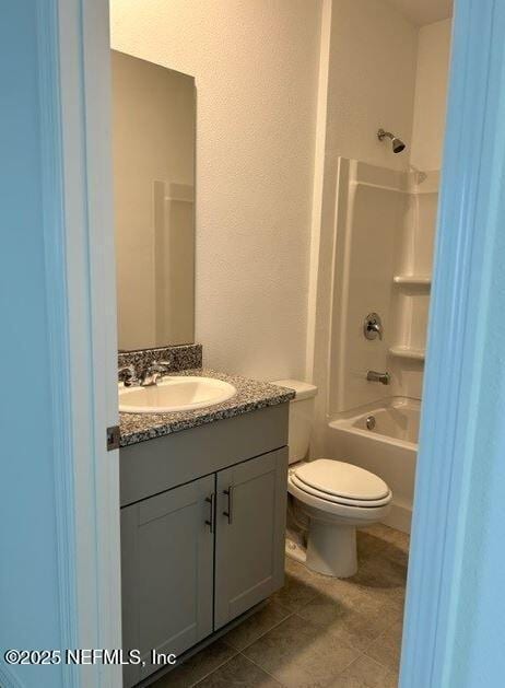 full bathroom featuring tile patterned flooring, vanity, toilet, and shower / bathtub combination