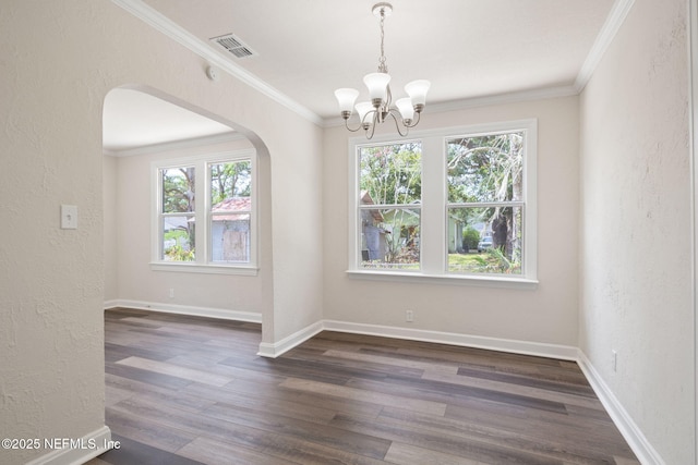 unfurnished dining area featuring a chandelier, crown molding, dark hardwood / wood-style flooring, and a healthy amount of sunlight