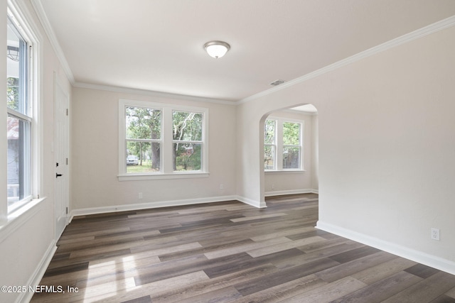 spare room featuring crown molding and dark wood-type flooring