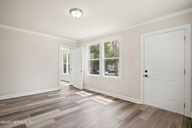 foyer entrance with hardwood / wood-style floors and crown molding