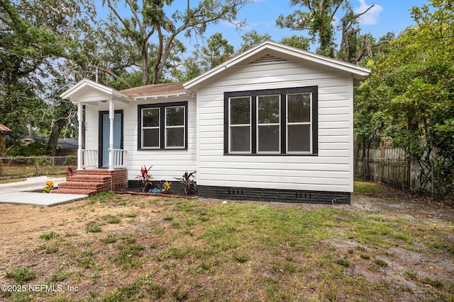 rear view of house with a yard