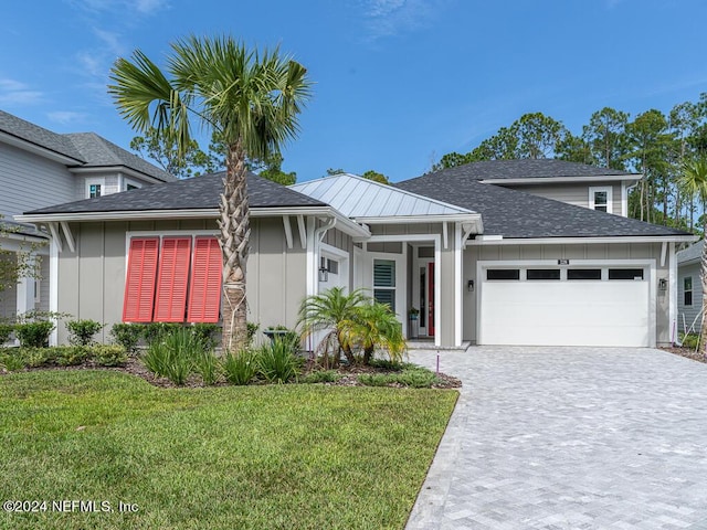 view of front of house with a front yard and a garage