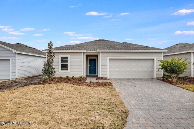 ranch-style house featuring a garage and a front yard