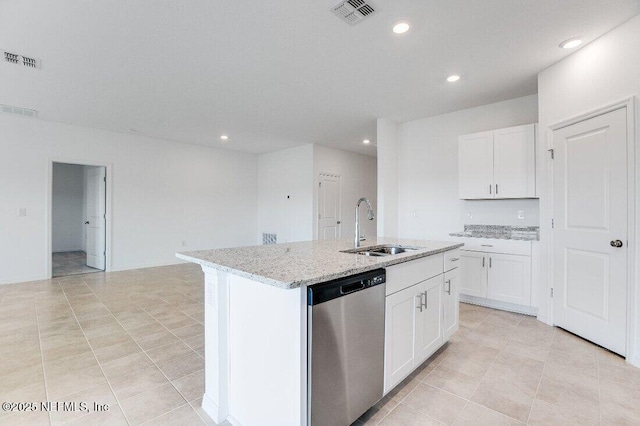 kitchen with white cabinetry, sink, a kitchen island with sink, stainless steel dishwasher, and light stone countertops