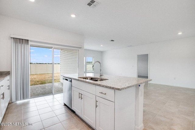 kitchen with sink, white cabinetry, light stone counters, a center island with sink, and stainless steel dishwasher