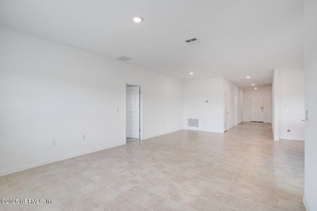 unfurnished room with light tile patterned floors